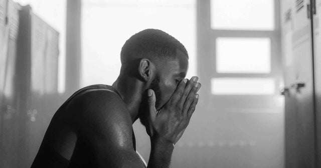 Man washing sweat and oil off his face after a workout