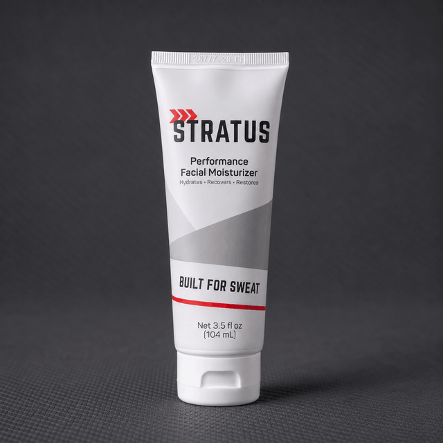 A white squeeze tube of Stratus Performance Facial Moisturizer, part of a post workout skincare routine, standing upright on a dark gray textured surface.