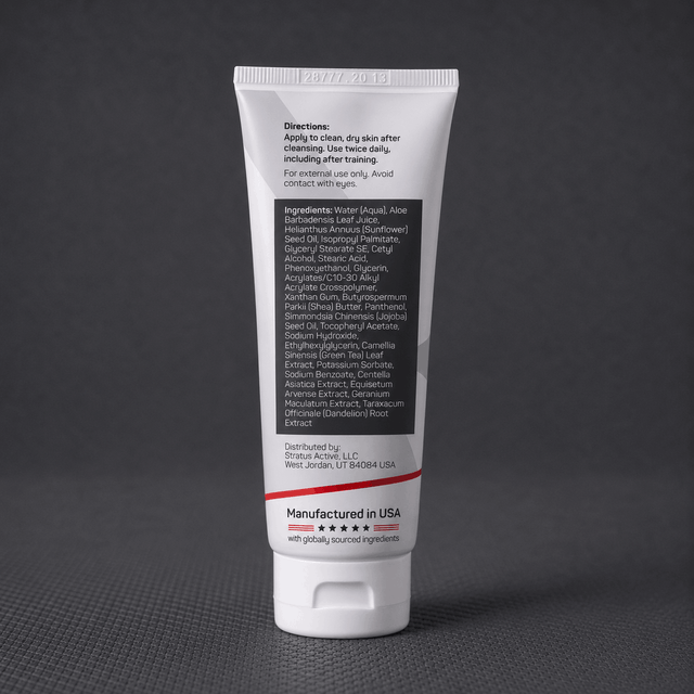 A white squeeze tube of Stratus Performance Facial Moisturizer, part of a post workout skincare routine, standing upright on a dark gray textured surface. The back view including ingredients is shown.