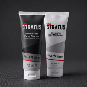 Two squeeze tubes that make up the Stratus Complete System, a post workout skincare routine, are shown on a dark background.