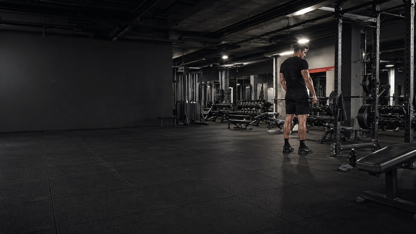 Person standing in a gym with equipment in the background